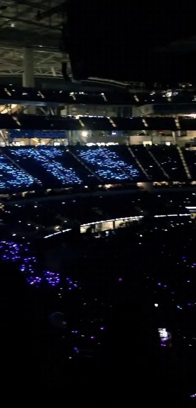 Stadium illuminated by blue lights at night, creating an electric atmosphere.