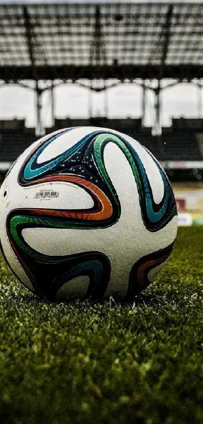 Soccer ball on green stadium field in focus foreground.