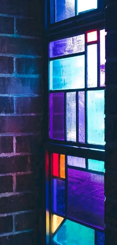 Colorful stained glass window against a brick wall.