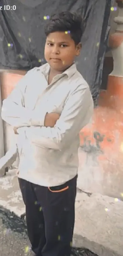 Young person standing confidently, arms crossed, in an urban setting with soft lights.