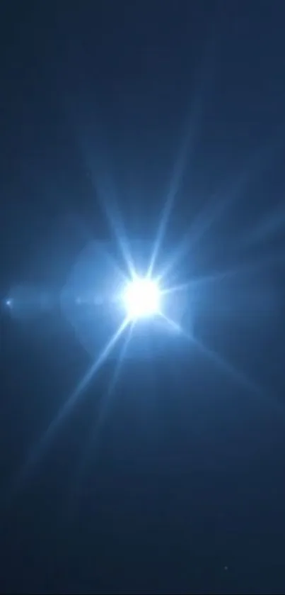 Radiant starburst light in a dark blue night sky.