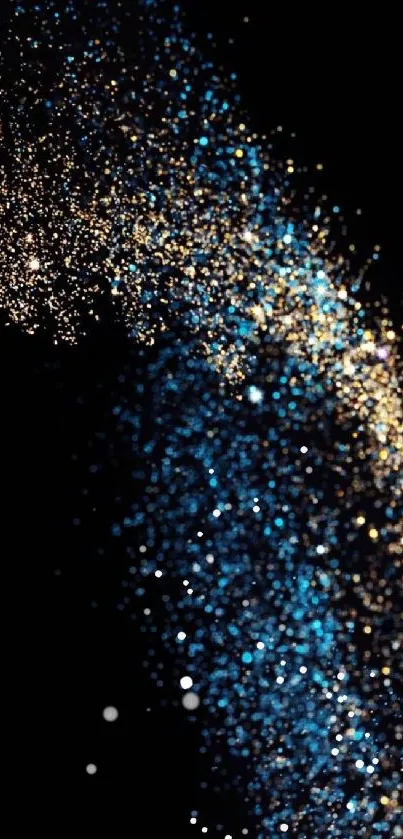 Blue and gold stardust particles on black background.