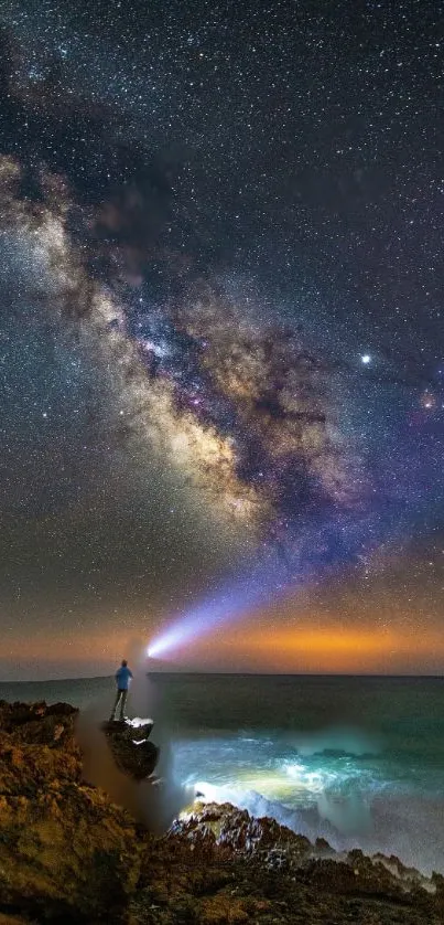 Milky Way galaxy over ocean cliffs at night.