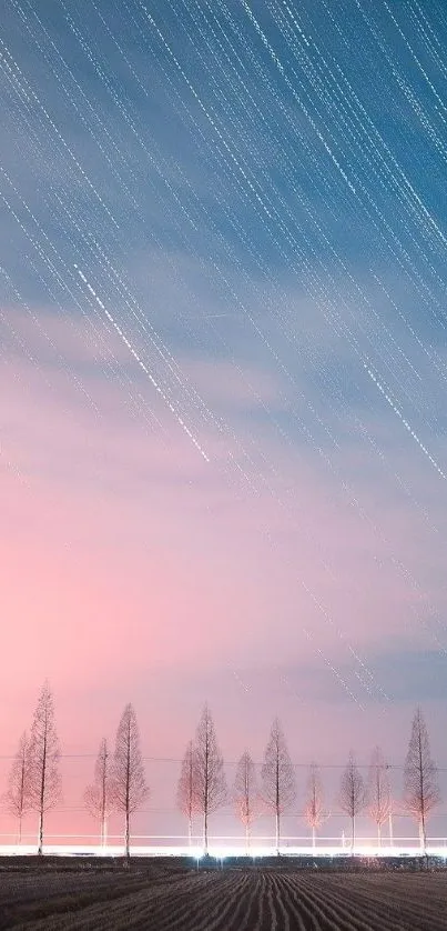 Silhouetted trees under a pink and blue stargazing sky.