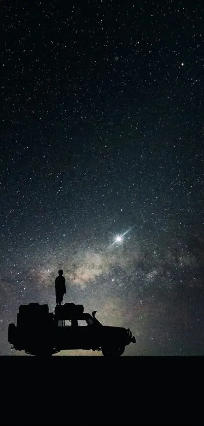 Silhouette of vehicle under starry night sky with Milky Way.