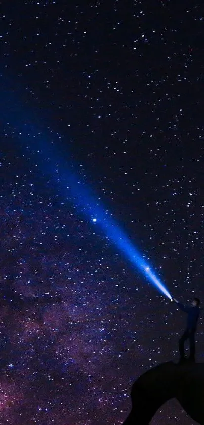 Person with flashlight under a starry night sky.