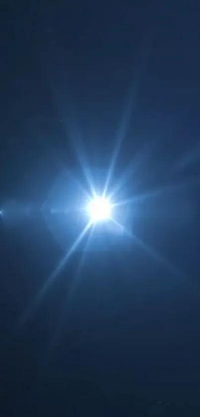 Dark blue wallpaper with a radiant star-like light in the center.