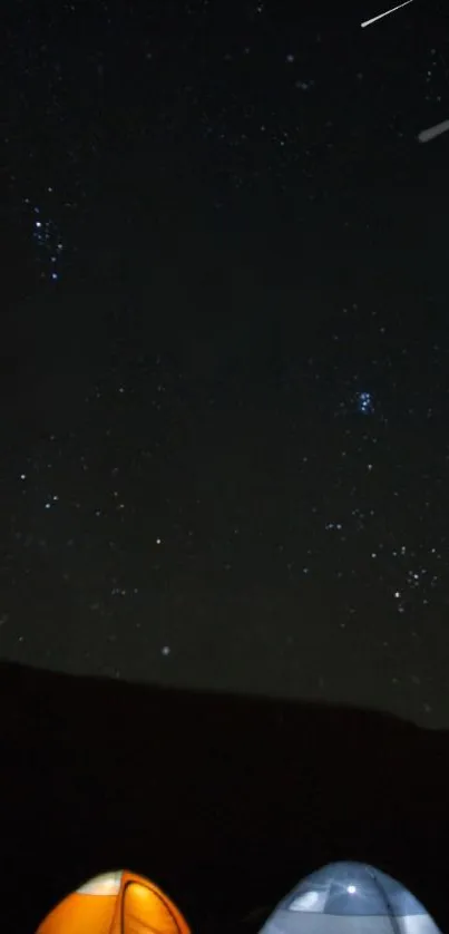 Night sky with stars over camping tents, serene outdoor scene.