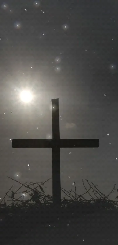 Silhouette of a cross against a starry night sky.