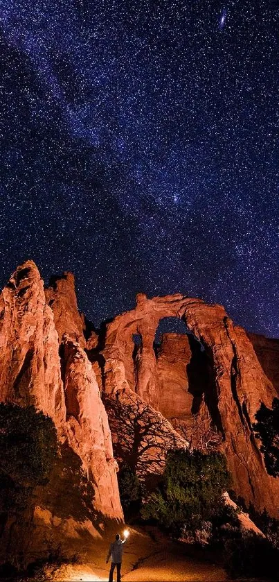 Majestic desert arch under a starry night sky.