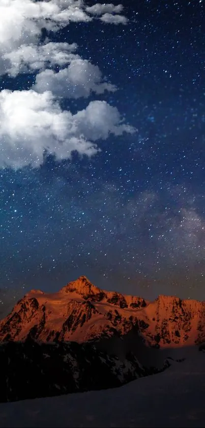 Starlit night sky over a mountain landscape with clouds.