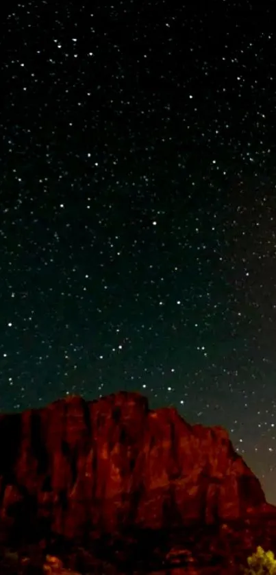 Stunning starlit night sky over rugged mountain silhouette wallpaper.