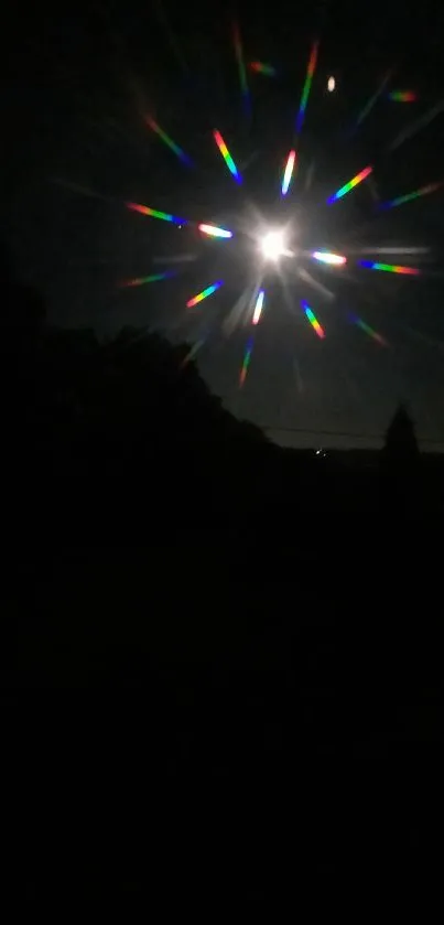 Starlit night with rainbow burst effect in dark sky.