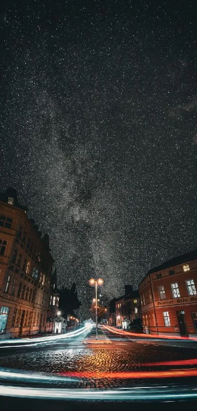 Star-filled sky above a city with light trails on a dark night.