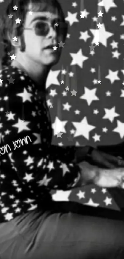 Person in star-patterned outfit at piano, monochrome theme.