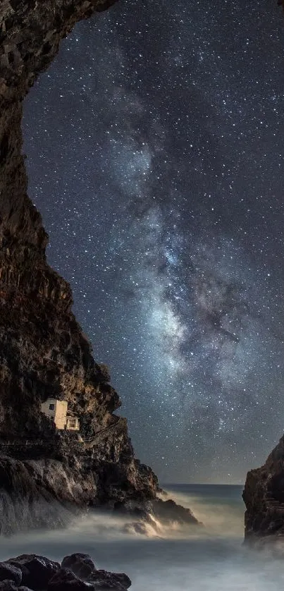 Starry sky through cave opening above ocean mist.