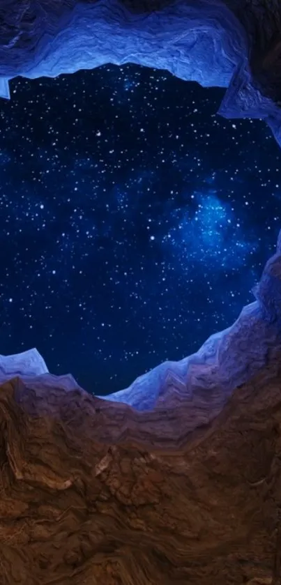 Starry sky seen through a rocky cave opening at night.