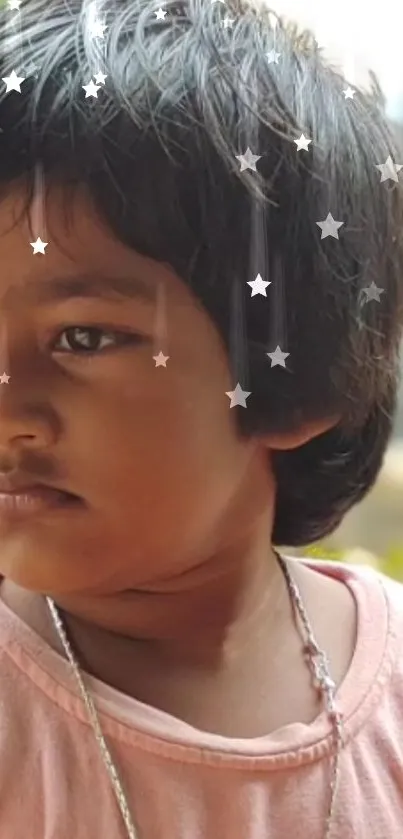 Child with a thoughtful expression and a starry overlay.