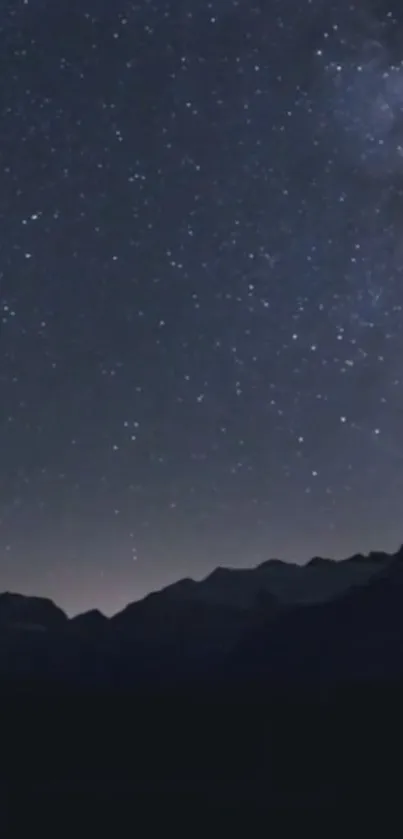 Starry night sky with mountain silhouette.