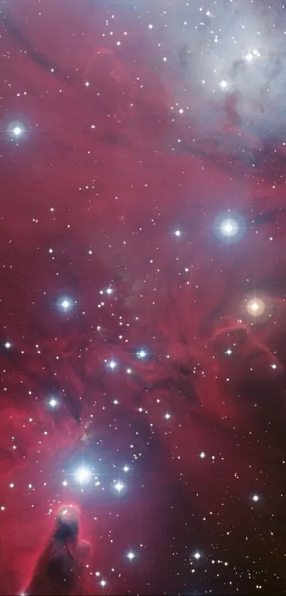 Vibrant red nebula with stars on a mobile wallpaper.