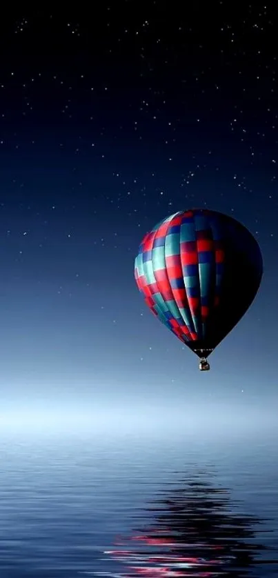 Starry night with hot air balloon over serene water reflection.