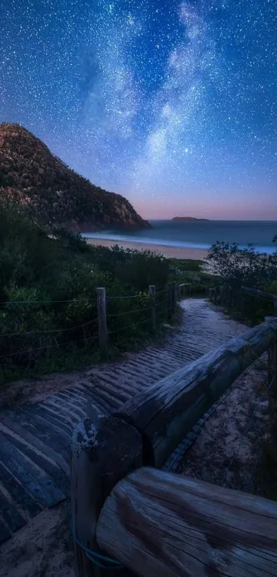 Starry night sky over a beach path with vivid blue tones.