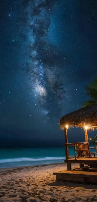 Stunning Milky Way over beach at night, with illuminated hut.