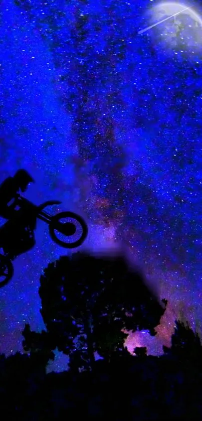 Silhouette of biker jumping under a vivid starry night sky.