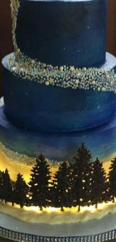 Three-tier cake with starry night theme and tree silhouettes.