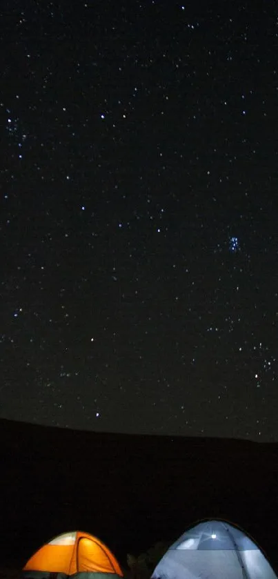 Camping scene with tents under a starry night sky.