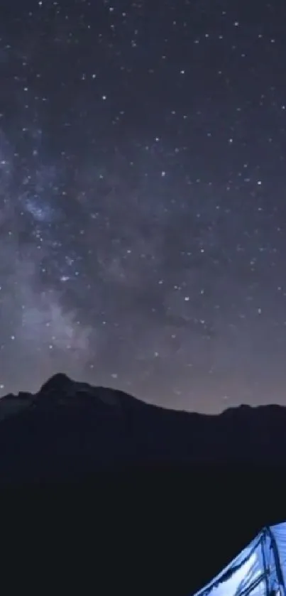 Camping tent under a starry night sky with a mountain silhouette.