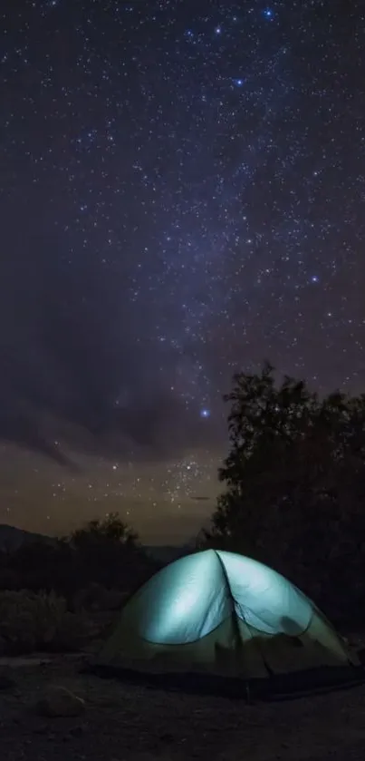 Camp lit under a starry night sky with glowing tent.