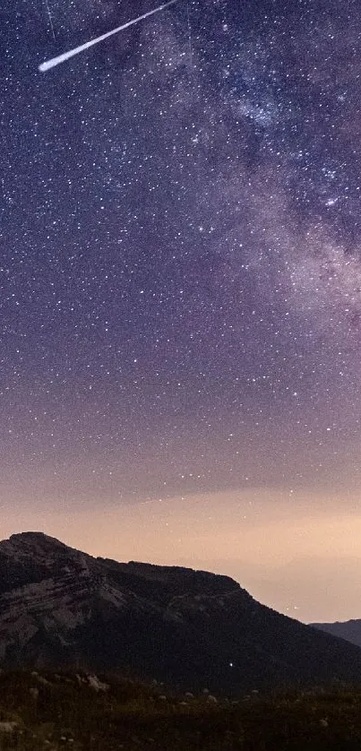 Camping under a starry night sky with the Milky Way and mountains in view.