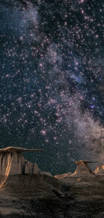 Starry night sky over rocky desert landscape under a galaxy of stars.