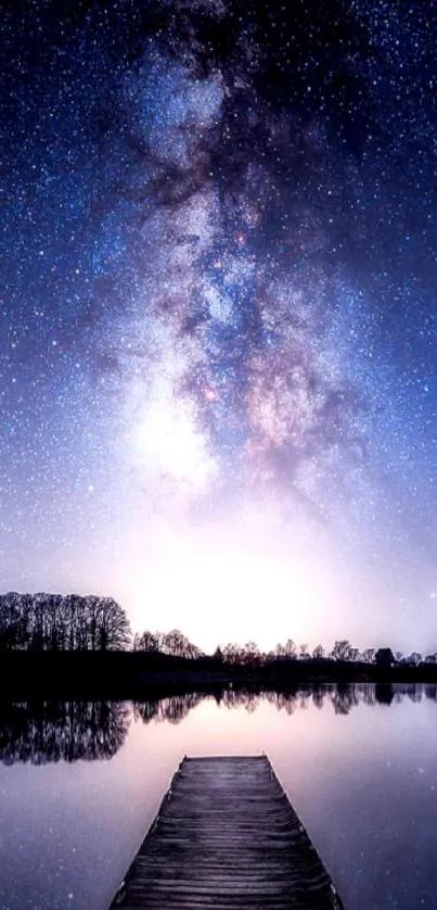 Starry night sky reflecting on a peaceful lake with trees in the distance.