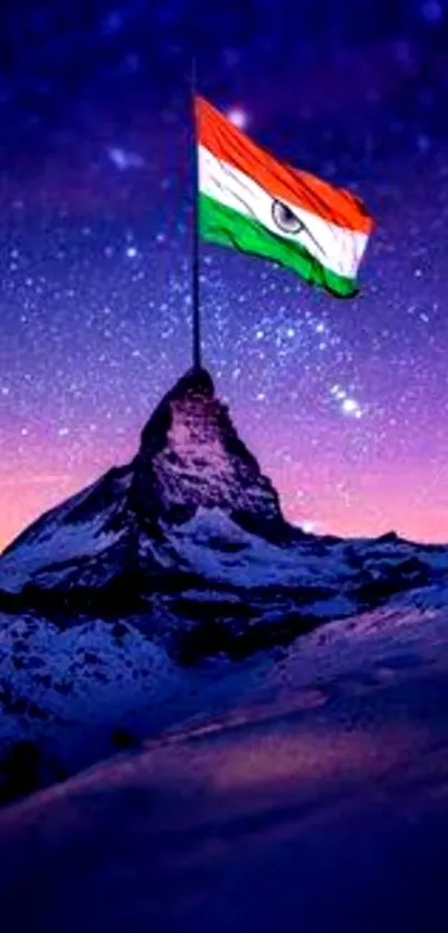 Mountain peak with Indian flag under a starry night sky wallpaper.