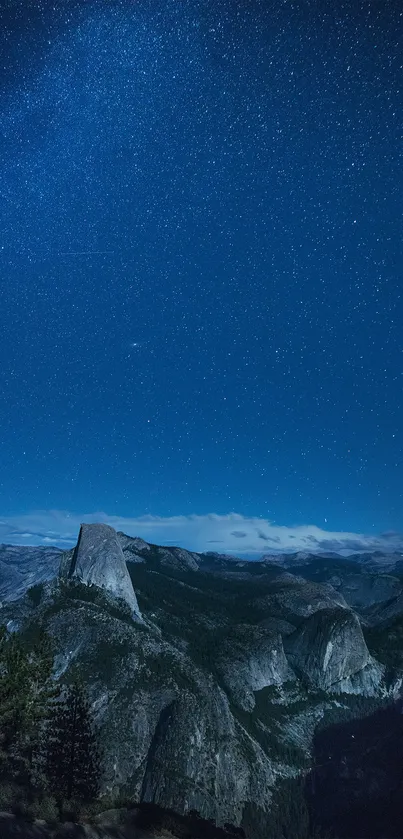 Starry night sky above mountain landscape wallpaper.