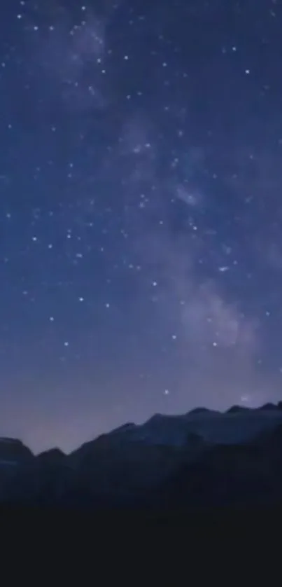 Starry night sky over mountains, perfect for mobile wallpaper.