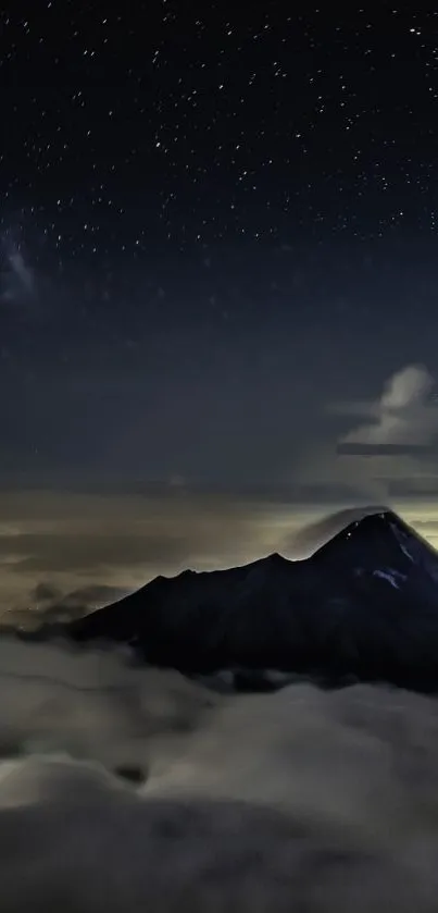 Majestic mountain under a starry night sky with clouds and celestial beauty.