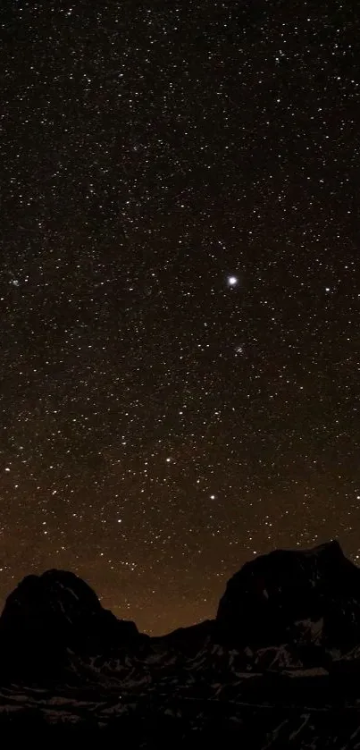 Starry night sky with mountain silhouette.