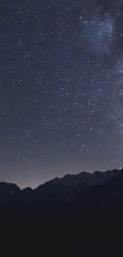 Starry night sky over mountain silhouettes, creating a serene and peaceful backdrop.