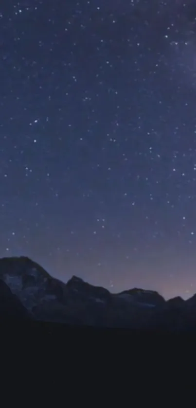 Majestic night sky with stars over mountains.