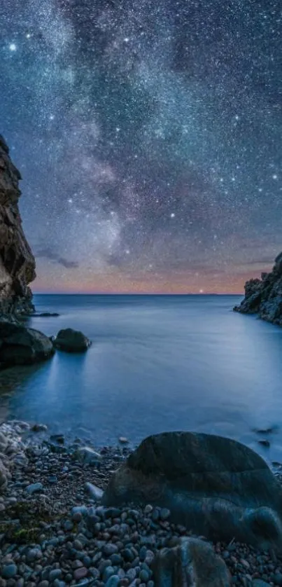 Starry night sky over a serene ocean cove between rocky cliffs.