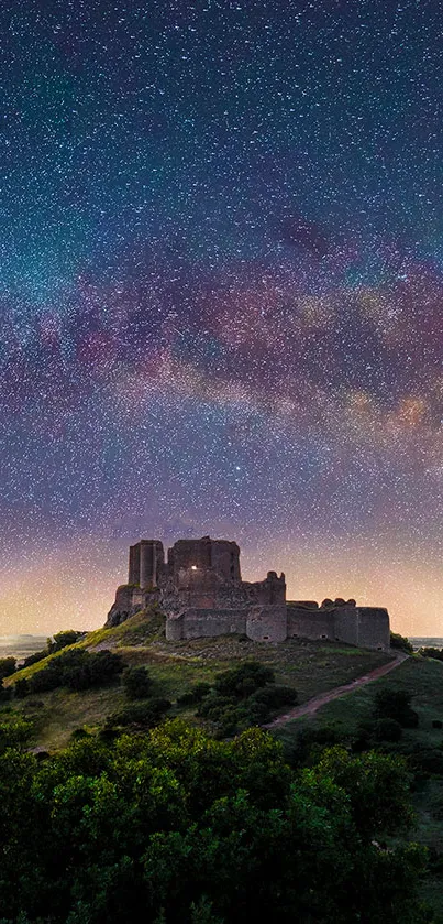 Starry sky with galaxy above an ancient castle at night.