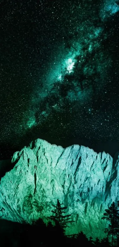 Starry sky over mountains with green glow.