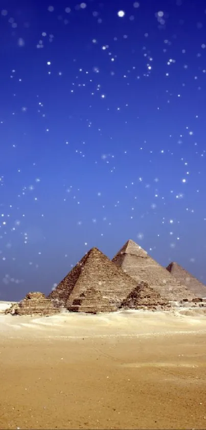 Giza pyramids under a starry night sky with a desert landscape.