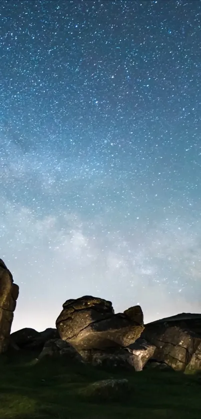 Starry night sky above rocky terrain with ambient lighting.