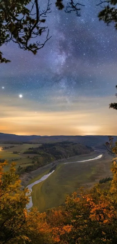 Starry night over a river and valley surrounded by autumn foliage.