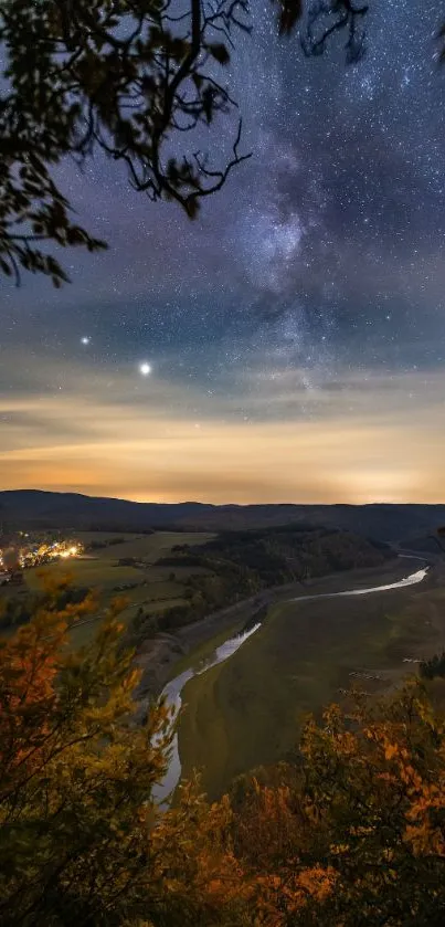 Starry night sky over river valley with autumn foliage and Milky Way view.