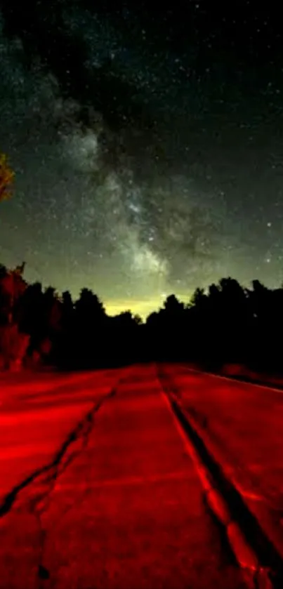 Starry night sky over a red illuminated road landscape.